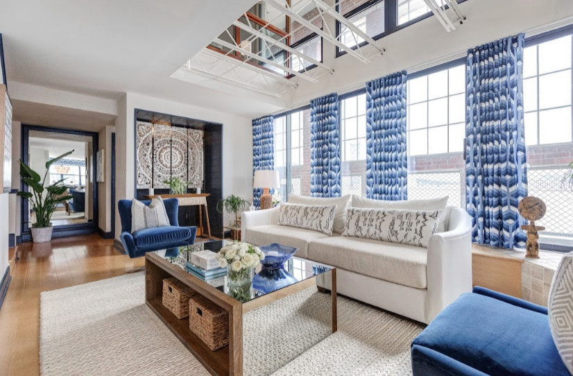 Design ideas for an expansive nautical formal open plan living room in Philadelphia with light hardwood flooring, a built-in media unit, white walls, beige floors and exposed beams.