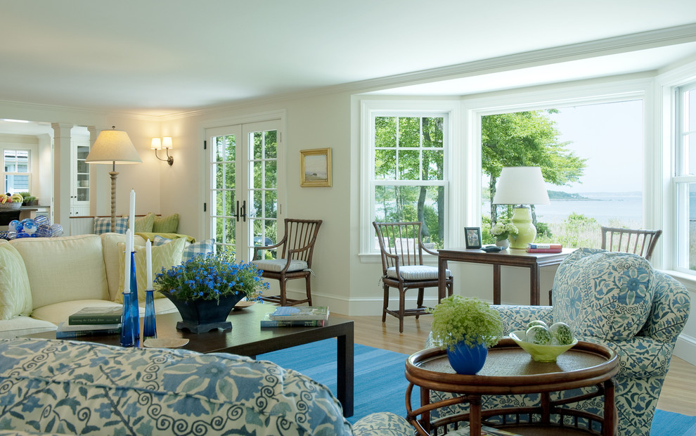 Inspiration for a coastal light wood floor living room remodel in Boston with white walls