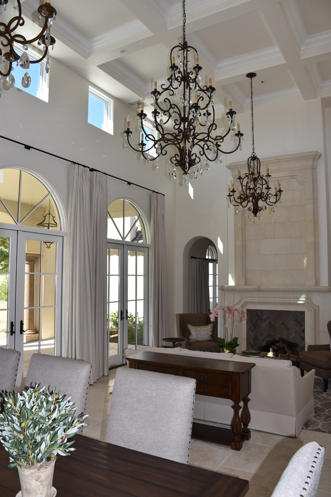 Inspiration for a medium sized mediterranean formal open plan living room in Phoenix with white walls, travertine flooring, a standard fireplace, a stone fireplace surround, no tv and beige floors.