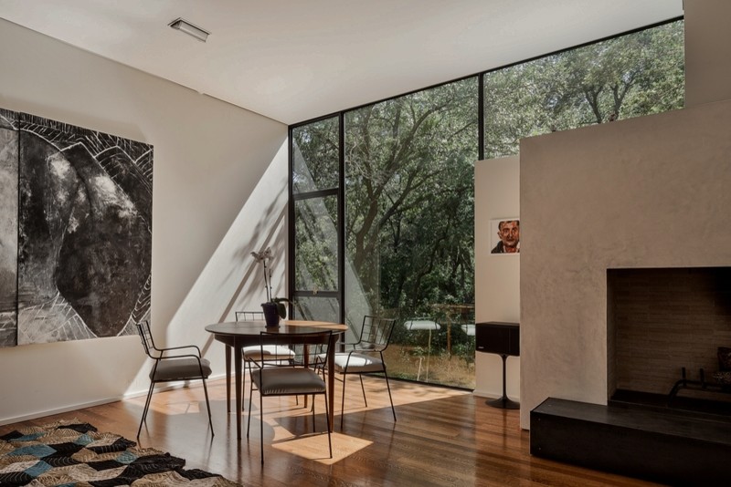Großes, Offenes Modernes Wohnzimmer mit hellem Holzboden und verputzter Kaminumrandung in Austin