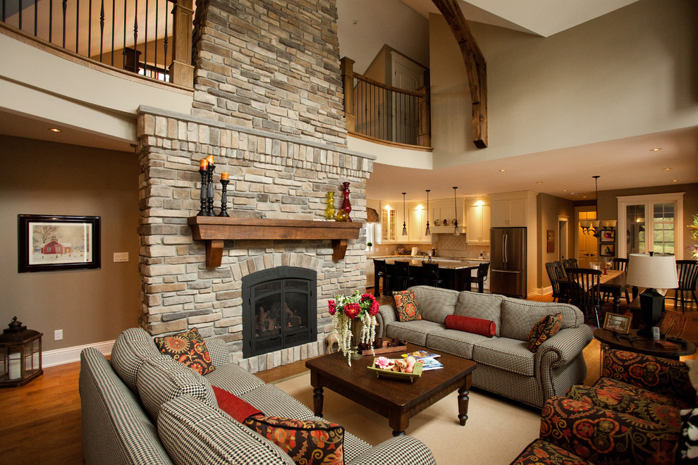 Living room - mid-sized rustic formal and open concept medium tone wood floor living room idea in Ottawa with brown walls, a standard fireplace, a stone fireplace and no tv