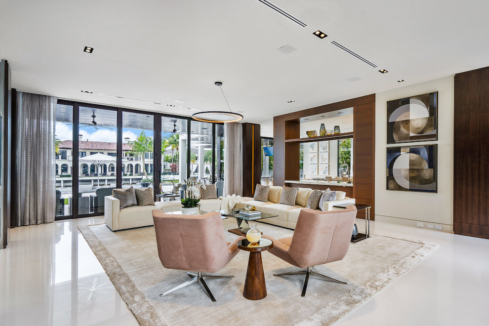 Large contemporary open plan living room in Miami with marble flooring, white floors and beige walls.