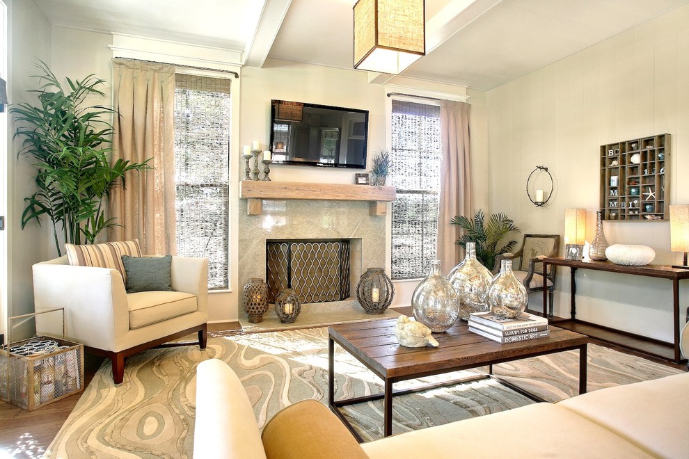 На фото: гостиная комната в современном стиле с стандартным камином и телевизором на стене с
