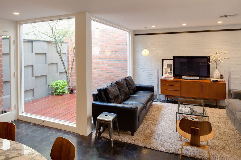 Idee per un soggiorno minimalista con pavimento in cemento