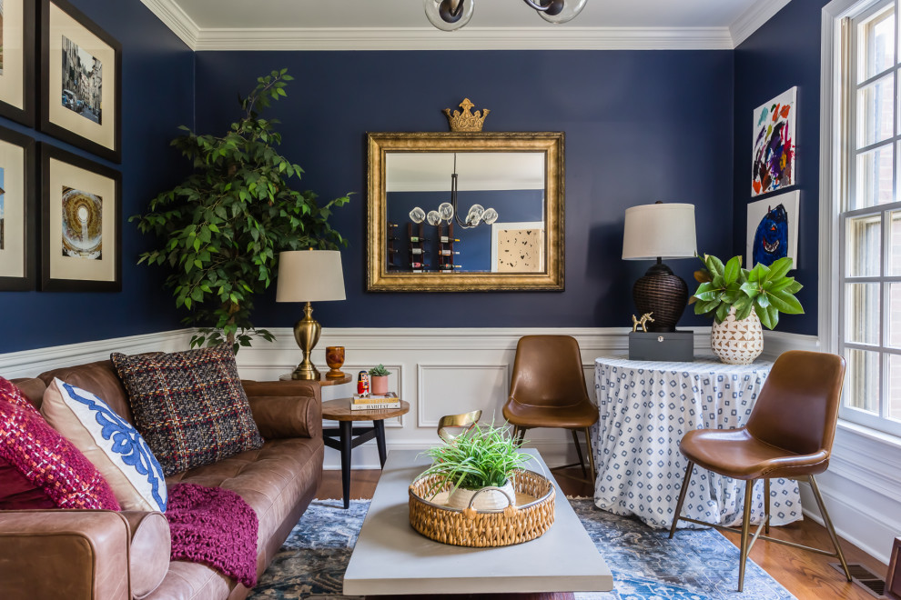Inspiration for an eclectic medium tone wood floor and brown floor living room remodel in Raleigh with blue walls