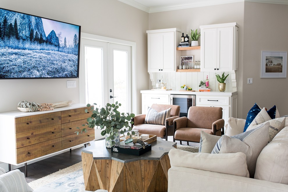 Ispirazione per un soggiorno classico con angolo bar, pareti beige, parquet scuro, TV a parete e pavimento marrone