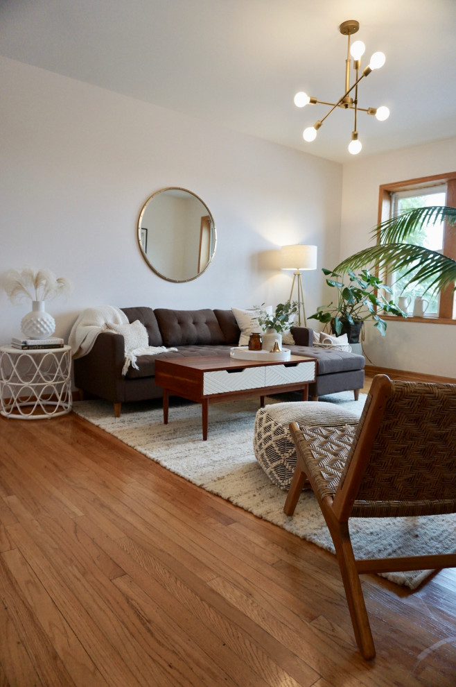 Small scandinavian enclosed living room in Chicago with beige walls, light hardwood flooring, no fireplace, no tv and beige floors.