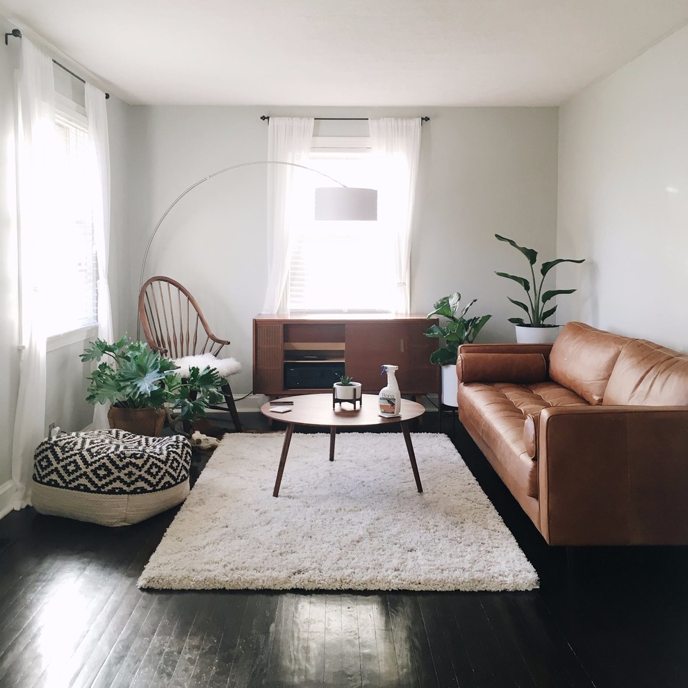 Photo of a medium sized midcentury open plan living room in New York with grey walls, medium hardwood flooring, no fireplace, no tv and brown floors.