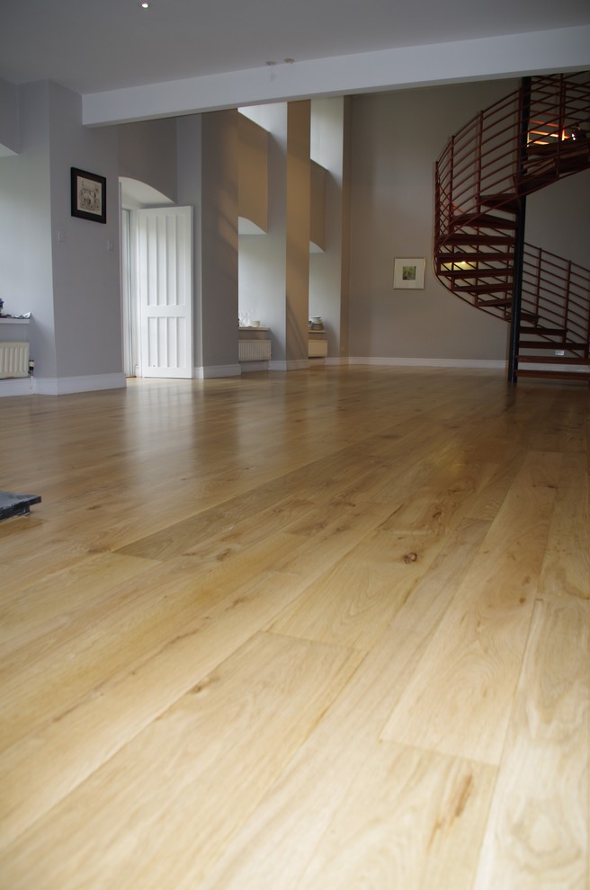 Photo of an expansive industrial enclosed living room in Other with medium hardwood flooring.