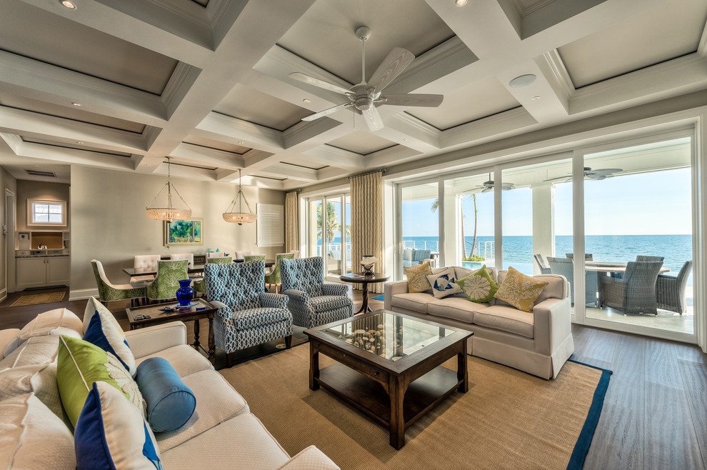 Inspiration for a large beach style open plan living room in Miami with dark hardwood flooring and beige walls.