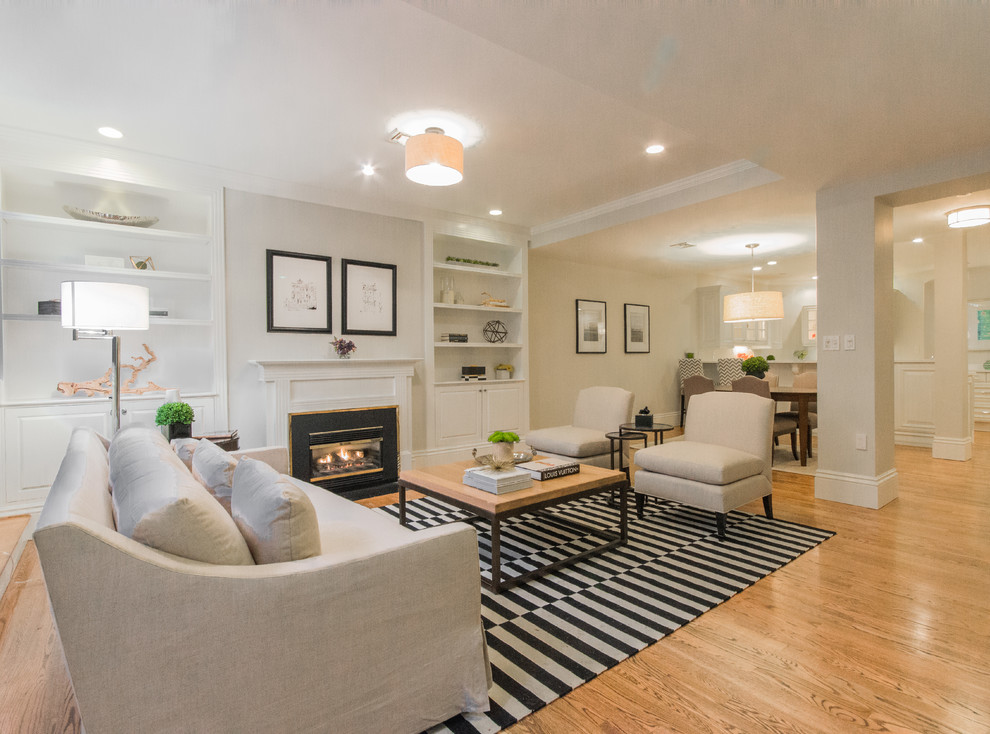 Example of a mid-sized classic open concept and formal light wood floor and beige floor living room design in Boston with beige walls, a standard fireplace and no tv