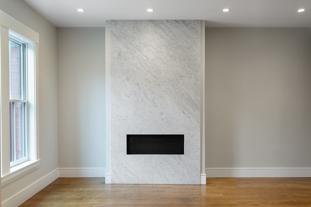 Imagen de salón abierto moderno de tamaño medio con paredes blancas, suelo de madera en tonos medios, chimenea lineal y marco de chimenea de piedra