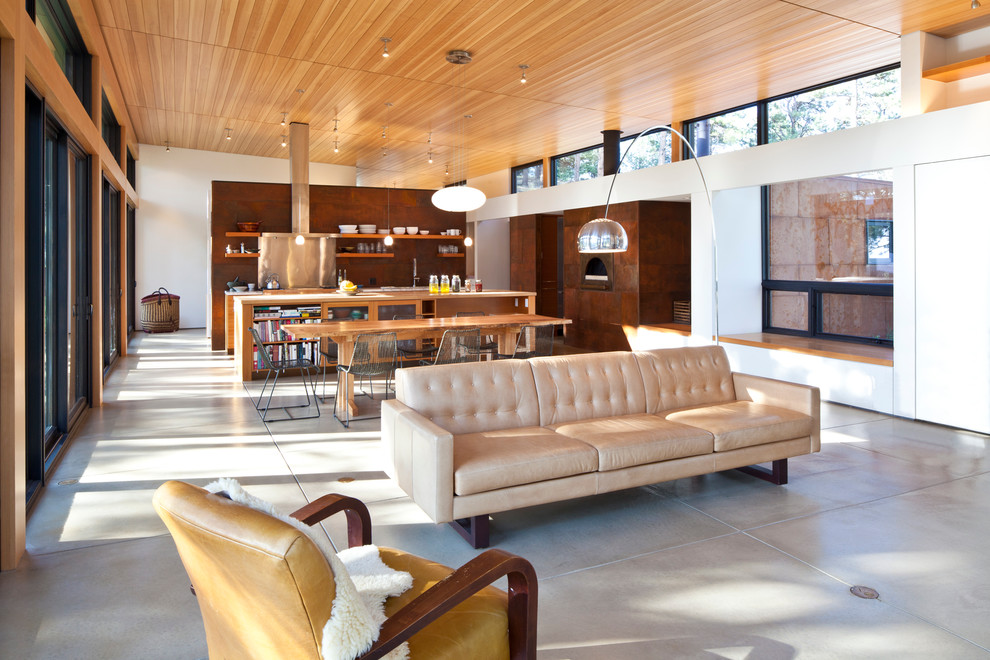 Стильный дизайн: открытая гостиная комната среднего размера в современном стиле с белыми стенами, бетонным полом и серым полом без телевизора - последний тренд