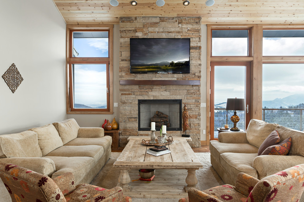 Design ideas for a contemporary living room in Denver with a stone fireplace surround and feature lighting.