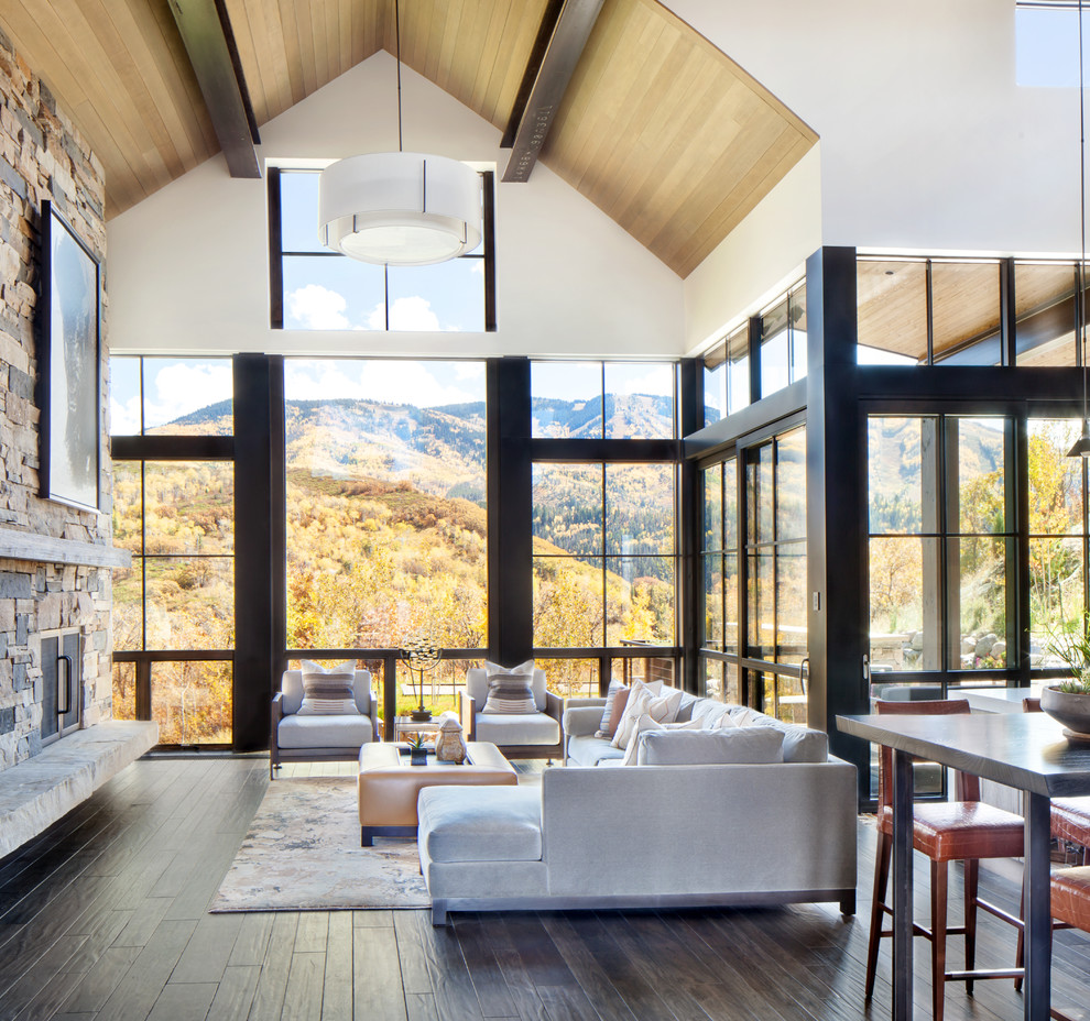 Large transitional formal and open concept dark wood floor and brown floor living room photo in Denver with white walls, a standard fireplace, a stone fireplace and no tv