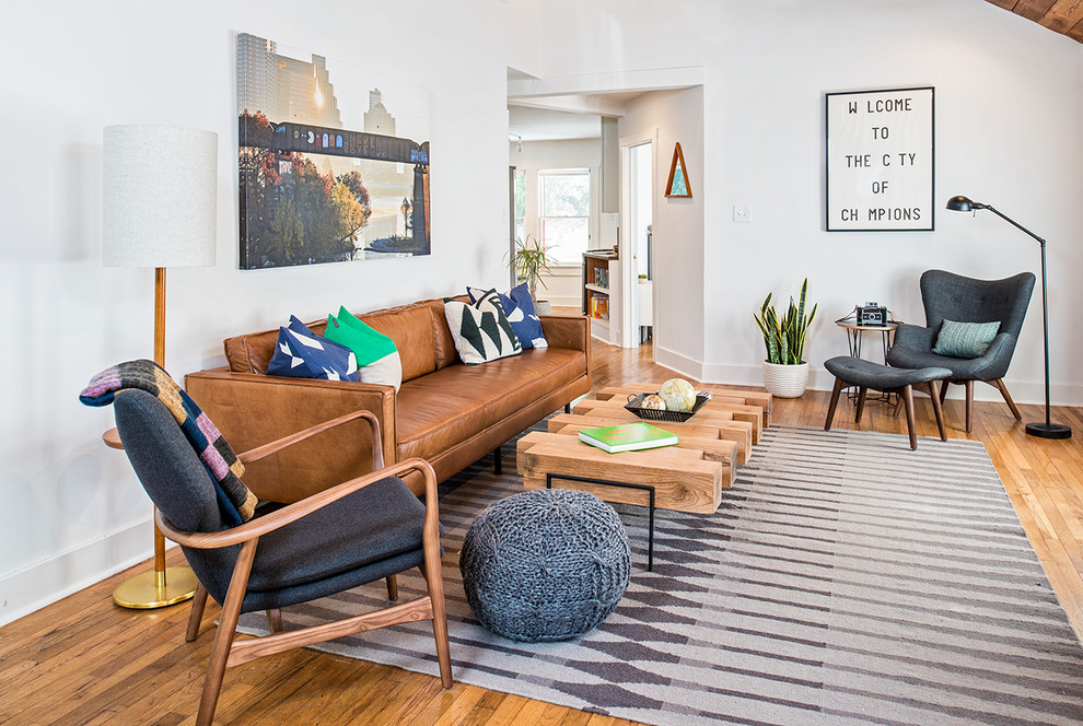 Inspiration for a mid-century modern medium tone wood floor living room remodel in Austin with white walls