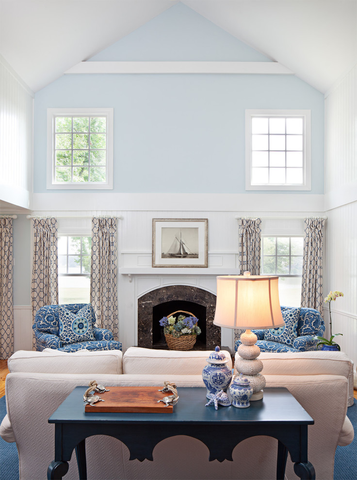 Foto de salón clásico sin televisor con paredes azules, todas las chimeneas y cortinas