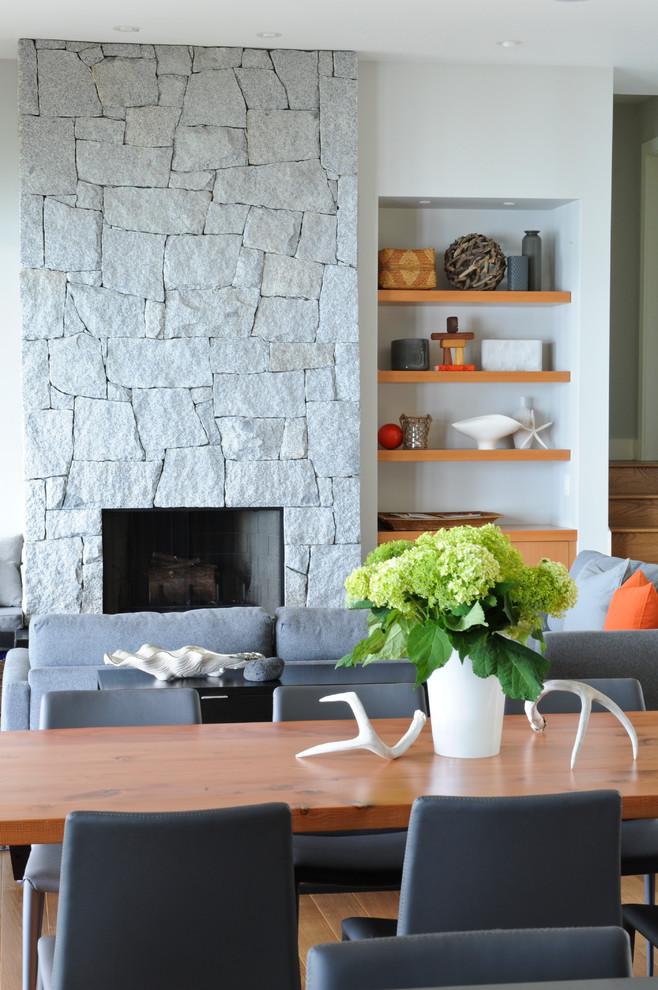 Photo of a contemporary living room in Vancouver with a stone fireplace surround.