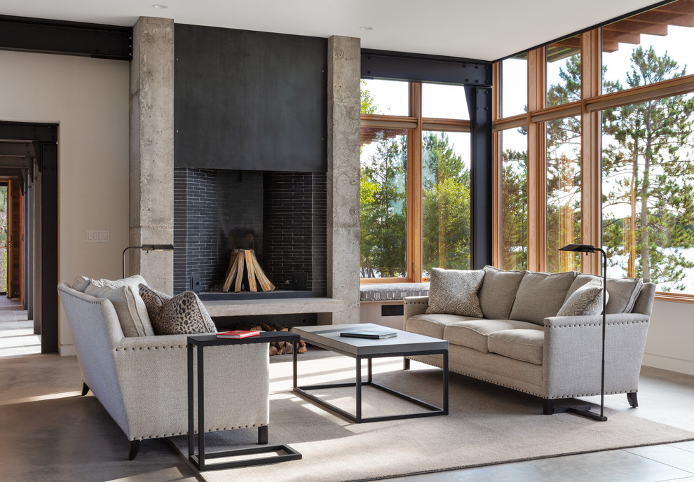 Photo of a contemporary open plan living room in Minneapolis with a standard fireplace, a tiled fireplace surround, grey floors and white walls.