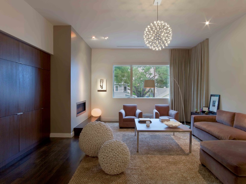 Contemporary living room in Houston with a ribbon fireplace.