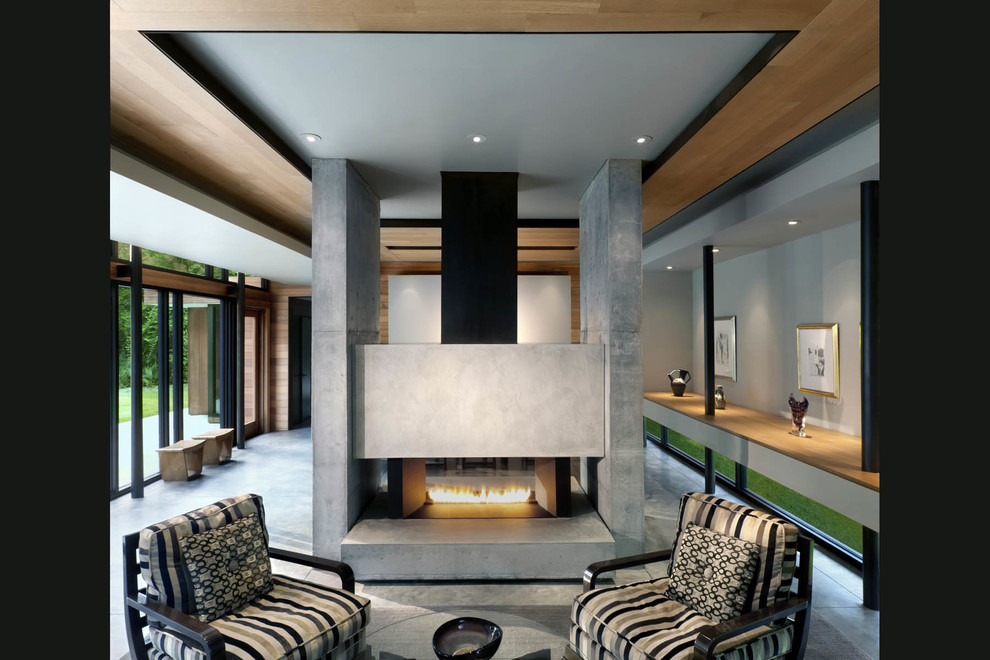 Idée de décoration pour un grand salon design ouvert avec une salle de réception, un mur gris, un sol en carrelage de céramique, une cheminée double-face et un manteau de cheminée en béton.