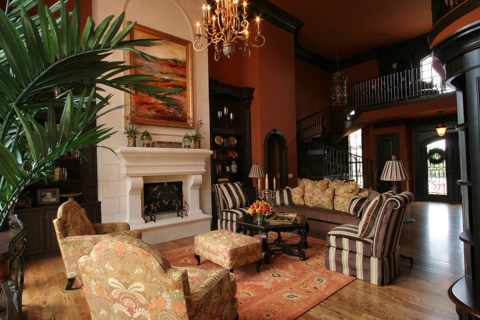 Inspiration pour un salon traditionnel avec une salle de réception, un mur orange, un sol en bois brun et aucun téléviseur.