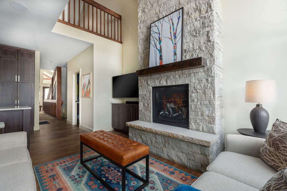 Kleines Klassisches Wohnzimmer im Loft-Stil mit weißer Wandfarbe, Keramikboden, Kamin, Kaminumrandung aus gestapelten Steinen, Eck-TV und braunem Boden in Denver