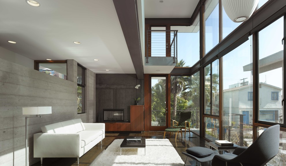 Inspiration for a modern living room in Los Angeles with grey walls and a standard fireplace.