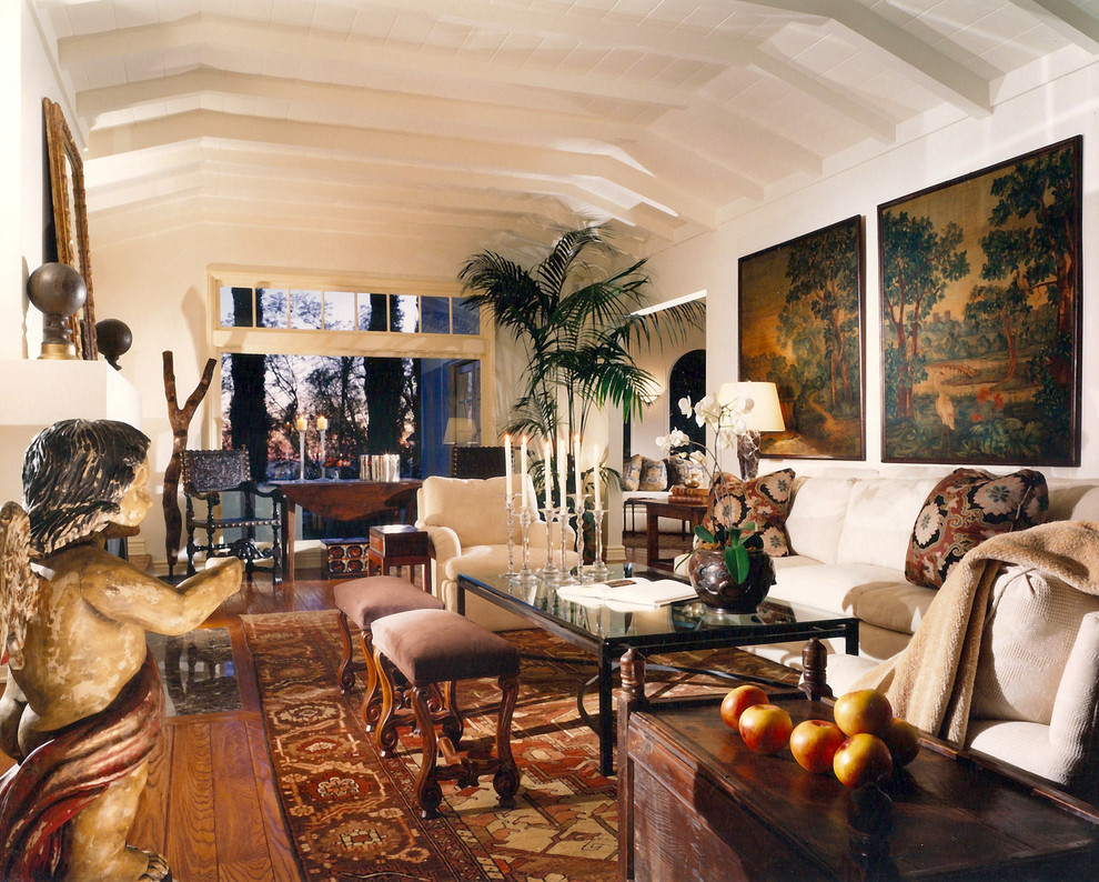 This is an example of an eclectic enclosed living room in Los Angeles with white walls and no tv.