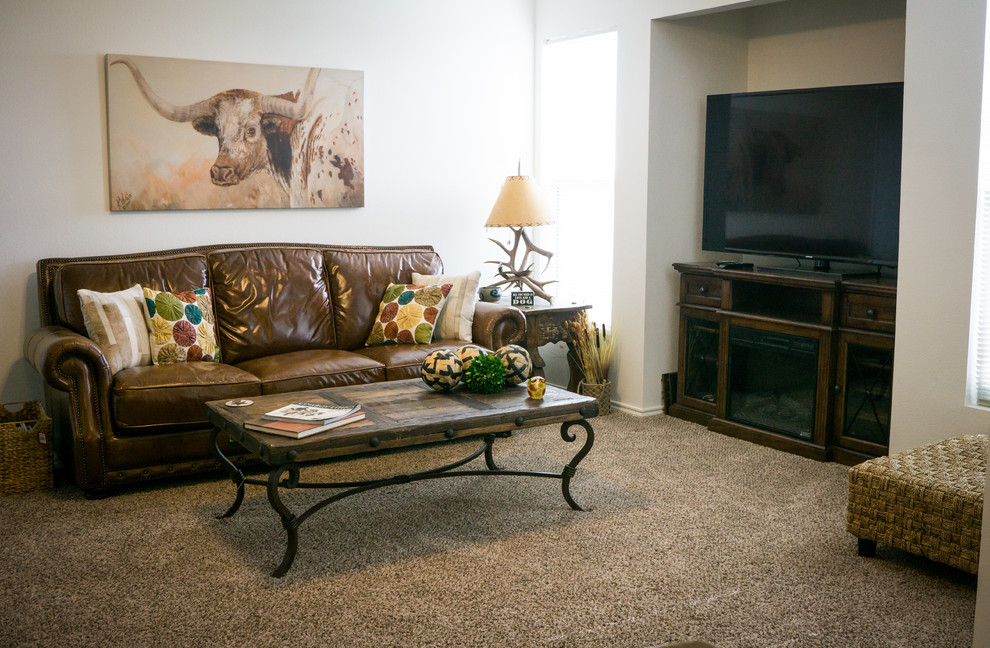 Inspiration for a mid-sized rustic enclosed carpeted and brown floor living room remodel in Austin with beige walls, no fireplace and a tv stand