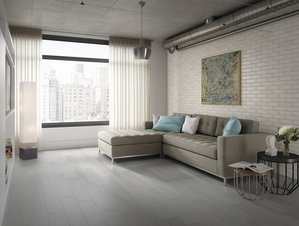 Photo of a large industrial open plan living room in Boise with white walls, porcelain flooring and a built-in media unit.