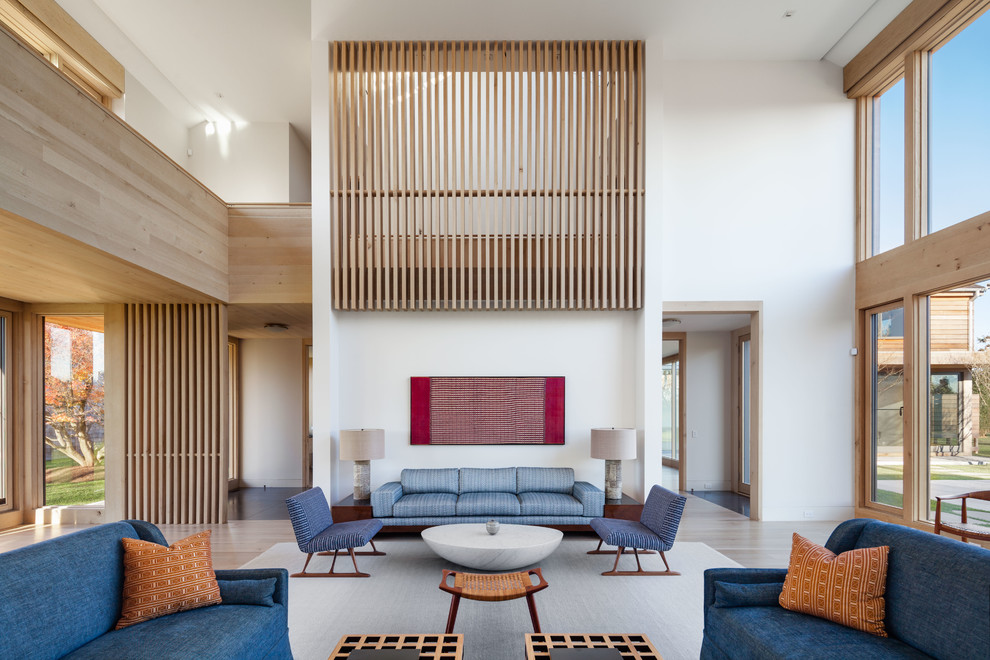 Large trendy formal and open concept light wood floor and beige floor living room photo in New York with white walls and no fireplace
