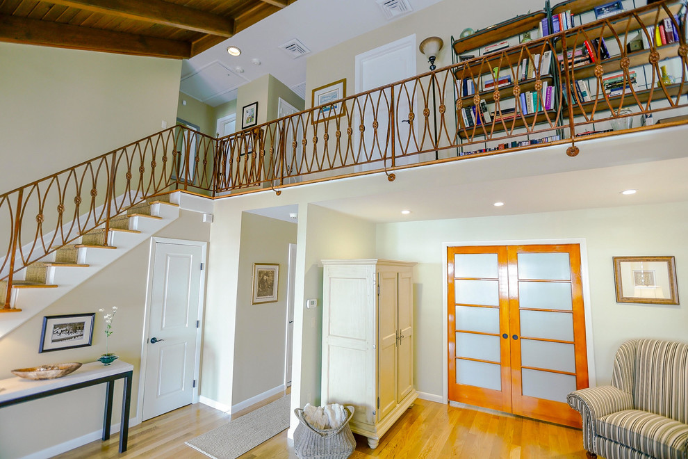 Photo of a large traditional formal mezzanine living room in Other with multi-coloured walls, light hardwood flooring, no fireplace, no tv and brown floors.