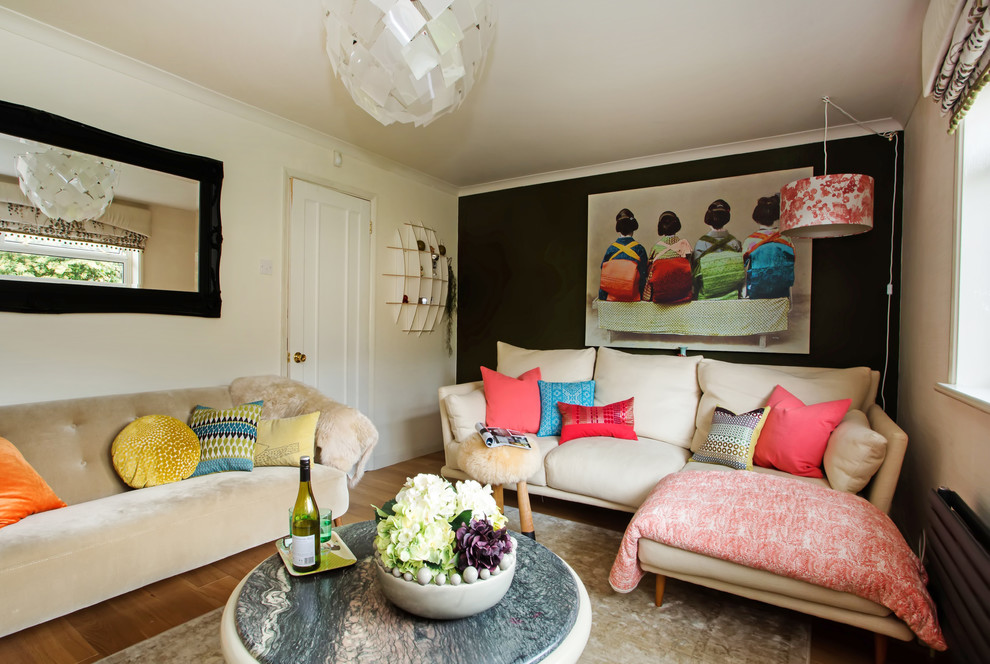 This is an example of a small eclectic enclosed living room in Berkshire with black walls.