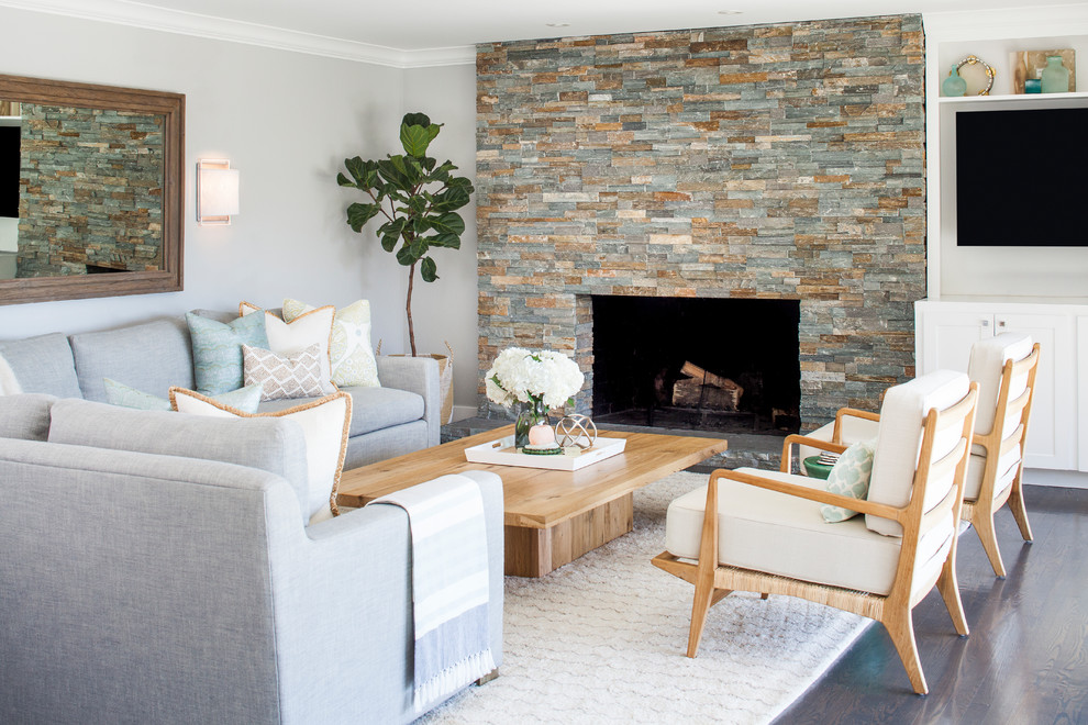 This is an example of a medium sized traditional open plan living room in Sacramento with grey walls, dark hardwood flooring, brown floors, a standard fireplace and a stone fireplace surround.