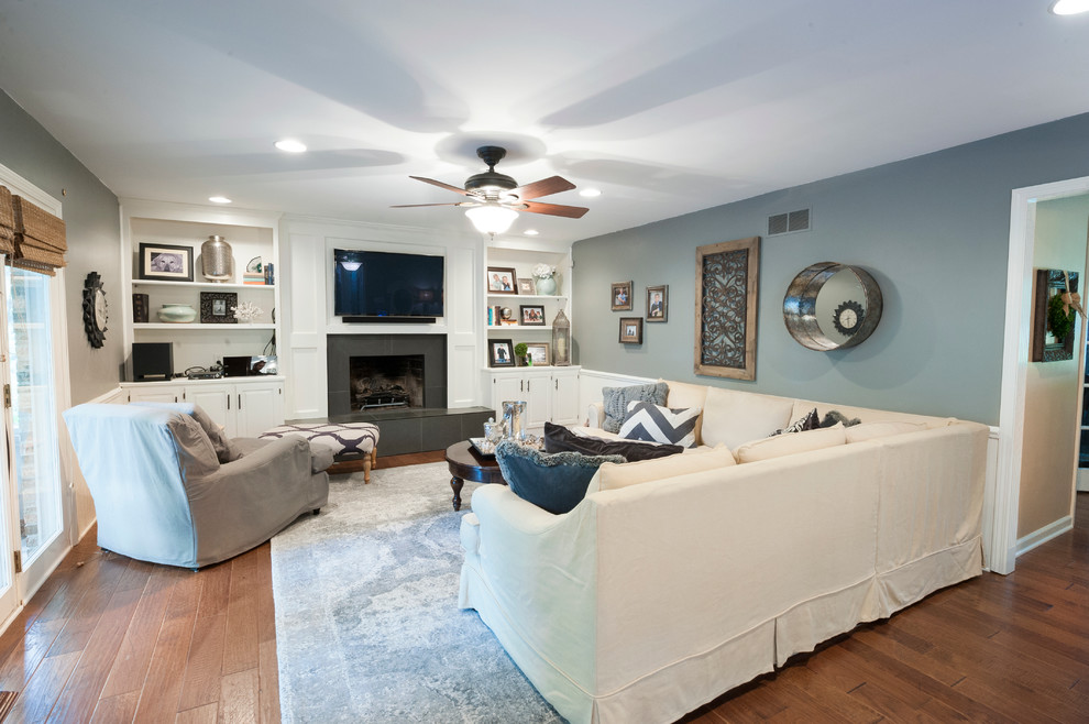 This is an example of a medium sized classic formal enclosed living room in Indianapolis with grey walls, dark hardwood flooring, a standard fireplace and a wall mounted tv.
