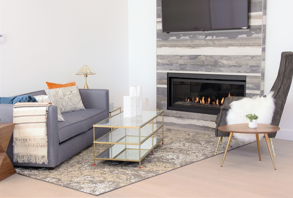 Inspiration for a medium sized contemporary open plan living room in Vancouver with white walls, laminate floors, a ribbon fireplace, a tiled fireplace surround, a wall mounted tv and beige floors.
