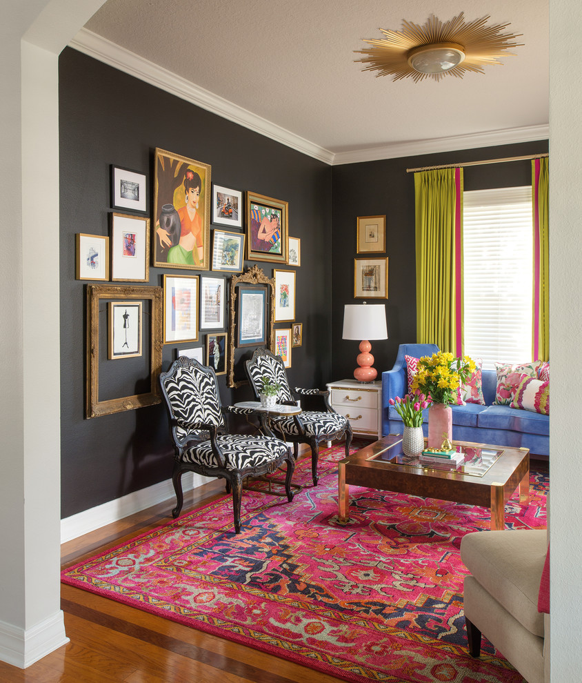 Inspiration for an eclectic light wood floor living room remodel in Tampa with black walls