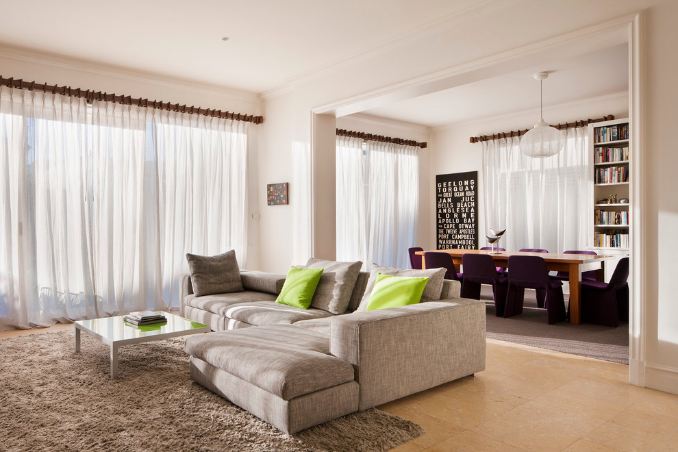 Example of a large trendy open concept travertine floor living room design in Melbourne with white walls