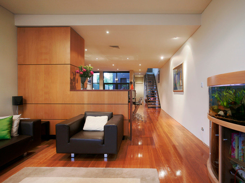 Example of a small trendy enclosed dark wood floor and orange floor living room library design in Perth with no tv