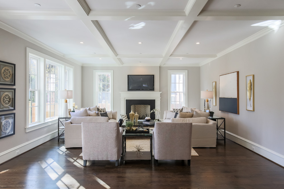 Classic living room in DC Metro with grey walls, dark hardwood flooring, a standard fireplace, a wall mounted tv and brown floors.