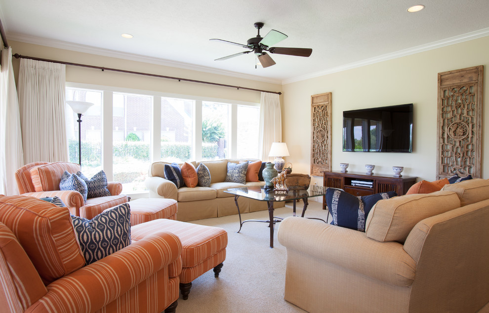 Example of a large classic open concept carpeted living room design in Houston with beige walls and a wall-mounted tv