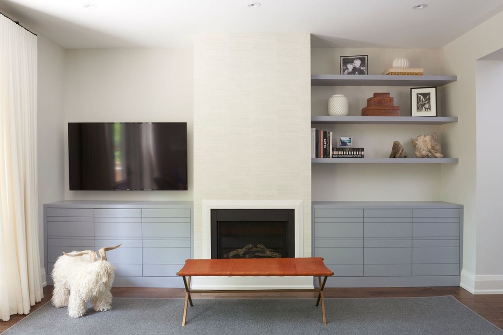 Mid-sized transitional open concept medium tone wood floor living room photo in Toronto with white walls, a standard fireplace, a plaster fireplace and a wall-mounted tv