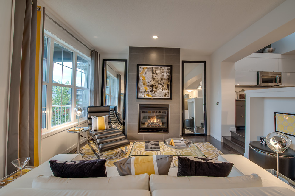 Contemporary living room in Calgary with white walls and a standard fireplace.