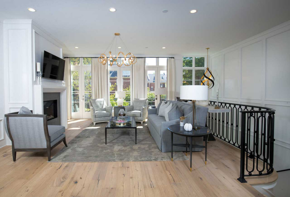 Example of a large trendy loft-style and formal multicolored floor, wainscoting and light wood floor living room design in Atlanta with white walls, a standard fireplace, a stone fireplace and a wall-mounted tv