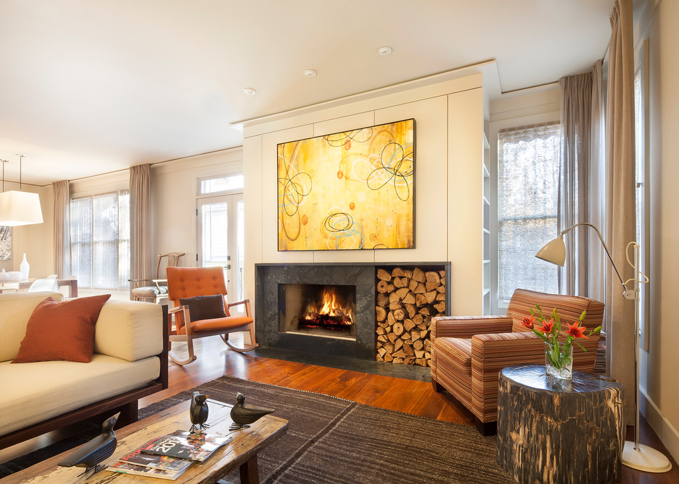 Inspiration for a mid-sized contemporary open concept medium tone wood floor and brown floor living room remodel in Atlanta with white walls, a standard fireplace, a stone fireplace and a wall-mounted tv
