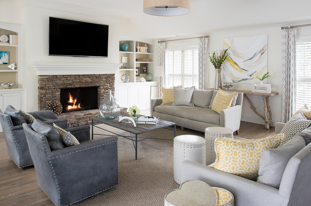 Inspiration for a transitional dark wood floor living room remodel in Atlanta with white walls, a standard fireplace, a stone fireplace and a wall-mounted tv