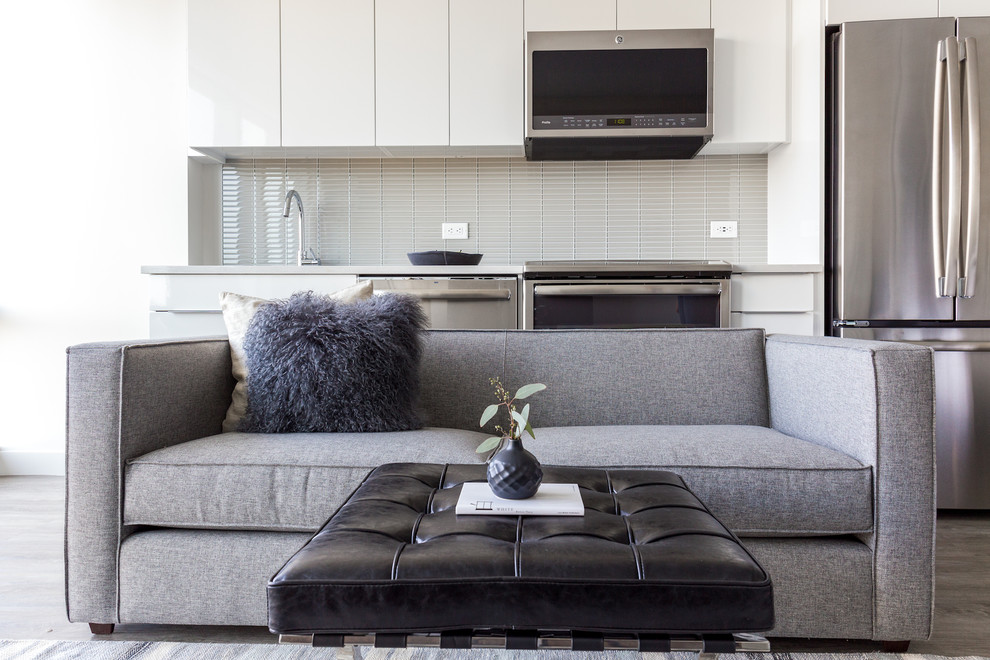 This is an example of a small modern open plan living room in Boston with light hardwood flooring and grey floors.