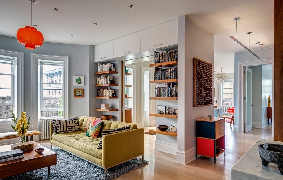 Design ideas for a retro formal open plan living room in New York with light hardwood flooring.