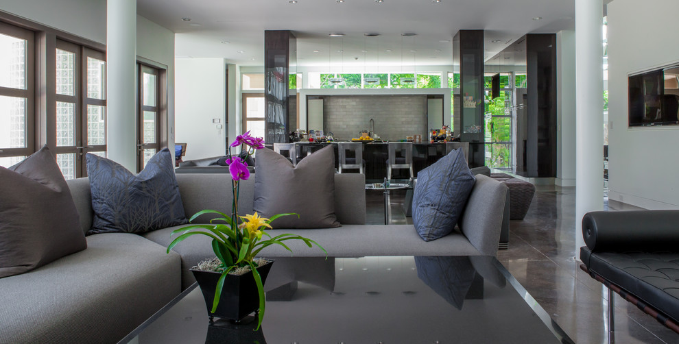 Photo of an expansive contemporary formal living room in Dallas with white walls, concrete flooring and a wall mounted tv.